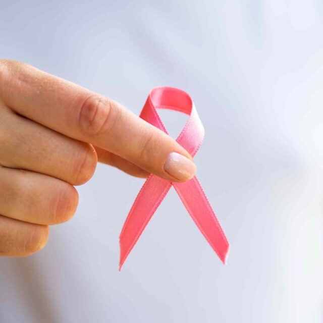 close-up-person-holding-awareness-ribbon (2) (1)